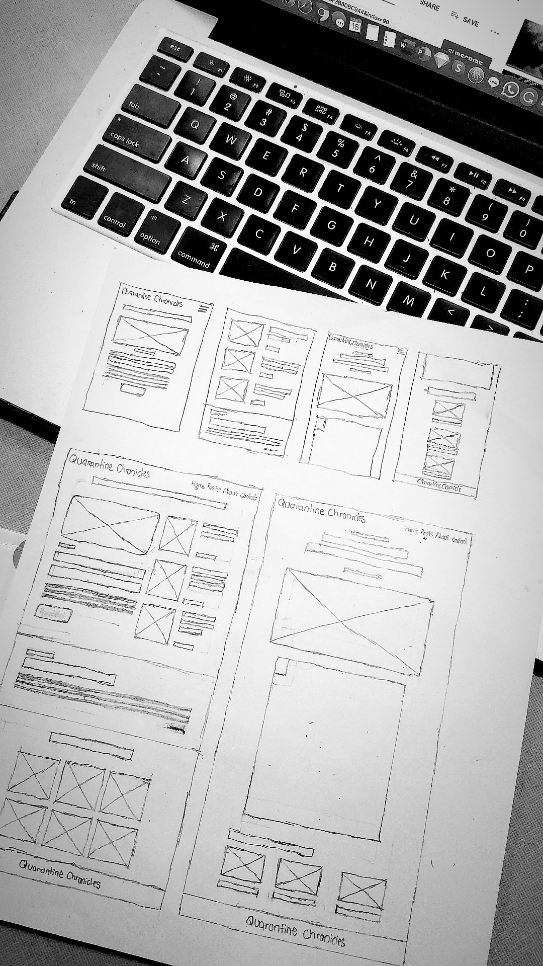 Wireframe of a blog site design. The design is placed on top of a Macbook Pro's keyboard. With an additional dark and black tone filter effect. By: Katherine Delorme